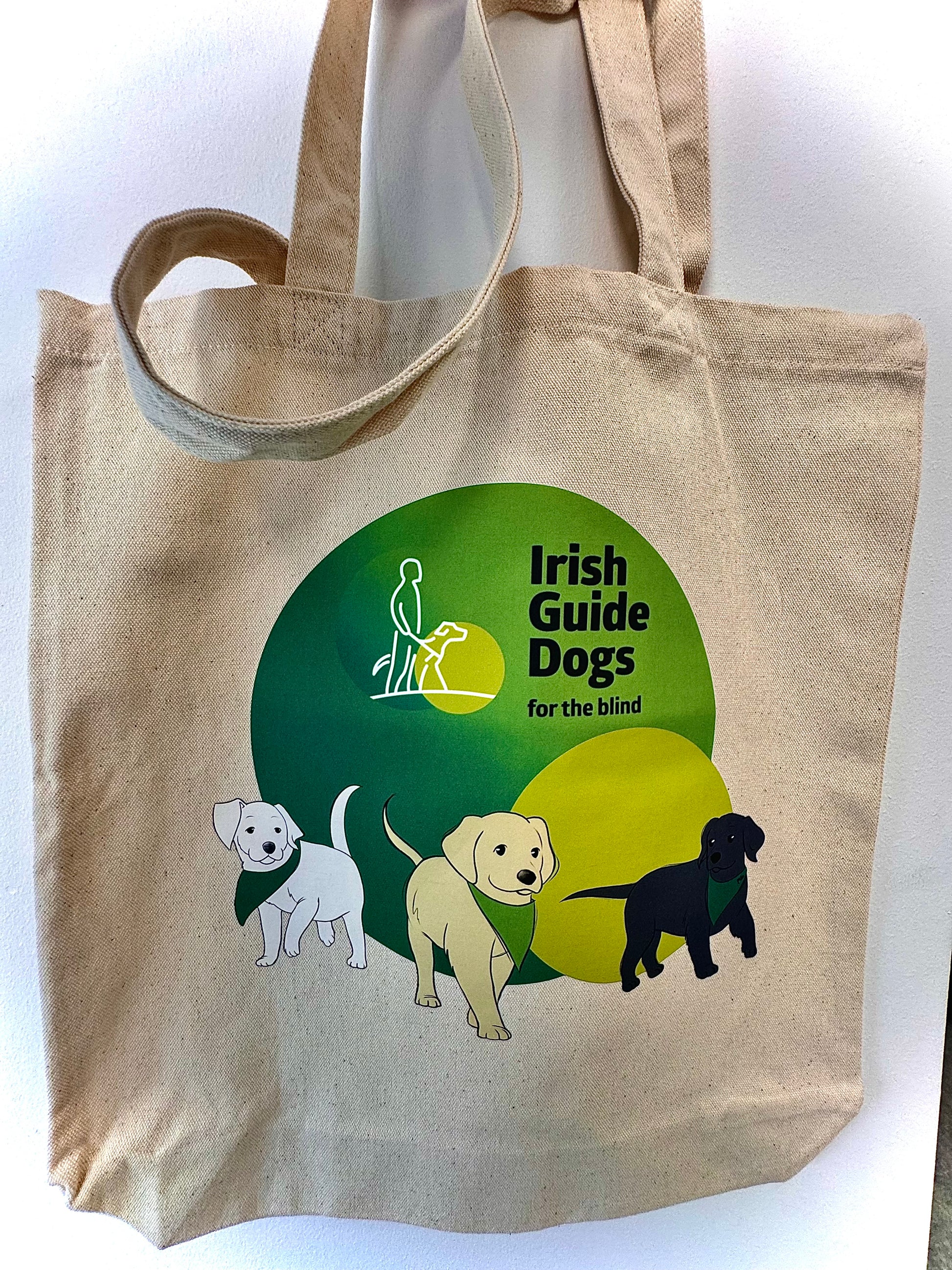 Canvas bag with Irish Guide Dogs for the Blind Logo and three illustrated puppies