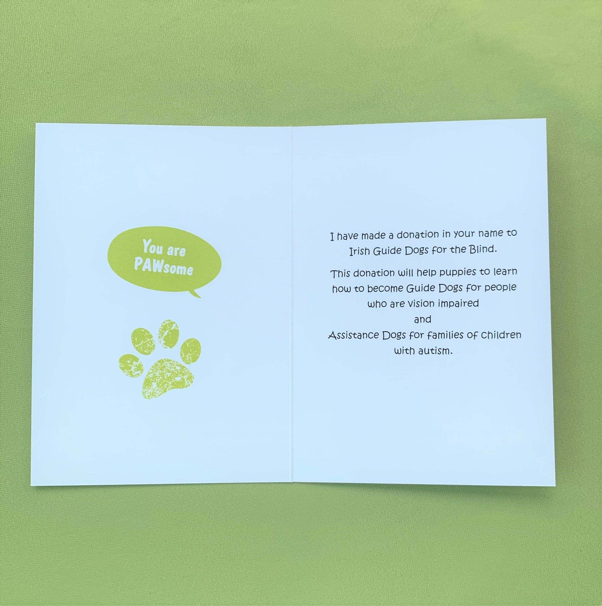 The inside of the card. On the left side saying you are pawsome with a pawprint. On the right side it says I have made a donation in your name to Irish Guide Dogs for the Blind.. This donation will help puppies to learn how to become Guide Dogs for people who are vision impaired and Assistance Dogs for families of children with autism. 
